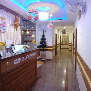 a lobby of a hospital with a christmas tree at Hotel Hebron Suites in Bengaluru