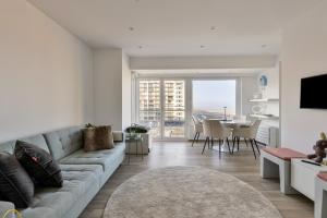 a living room with a couch and a dining room at Appartement San Marino 4B in Middelkerke