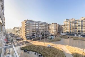 a city with tall buildings and a street with cars at Appartement San Marino 4B in Middelkerke