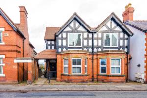 an old house with black and white windows at Spacious 3-Bedroom Retreat with Modern Amenities in Hawarden