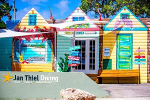 a colorful house with a sign in front of it at Sonesta Hotels & Resorts Livingstone Curacao in Willemstad