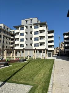 a large white building with a lawn in front of it at Mulatas y Mar in Vilagarcia de Arousa