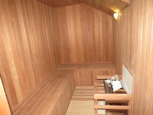 a sauna with wooden walls and a wooden floor at Carballo Hotel & Spa in Campos do Jordão