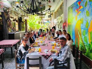 a group of people sitting at a table in a restaurant at Hotel Colonial - Salamina Caldas in Salamina