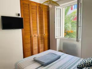 a bedroom with a bed with a pillow on it at Appartement lumineux Côte des Basques in Biarritz