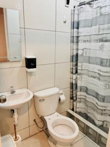 a bathroom with a toilet and a sink at Comfortable House in Punta Hermosa