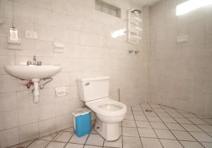 a bathroom with a toilet and a sink at Hostal Santa Anna in Xalapa +37 photos