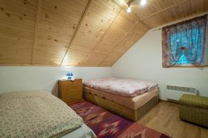 a small bedroom with two beds and a window at Apartmán Milka in Demanovska Dolina