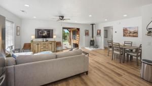 a living room with a couch and a table at Arrowleaf Family House with Hot Tub in Kanab +30 photos