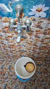 a cup of coffee sitting on top of a sink at Ashwin Home Stay 2 in Tiruvannāmalai