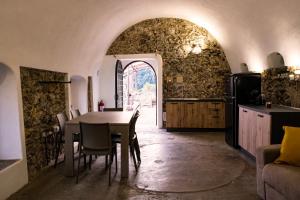 a kitchen and dining room with a table and chairs at Almaris in Erchie