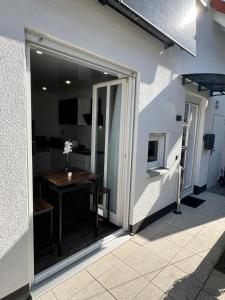 a sliding glass door leading to a patio with a table at Apartment Maja in Hungen
