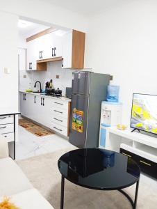 ナイロビにあるSmartHomes B1309 Studioのキッチン(ステンレス製の冷蔵庫、テーブル付) +3枚の写真
