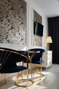 a dining room with a table and two chairs at Royal Elegance Apartment in Bucharest