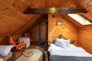 a room with two beds in a attic at Casa Valasoaia in Săcele
