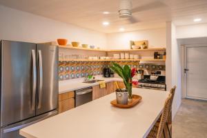 a large kitchen with a stainless steel refrigerator at El Oasis-Beachfront paradise in Manzanillo