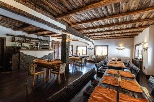 a dining room with wooden tables and chairs at Casa Valasoaia in Săcele