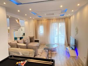 a living room with a couch and a pool table at Big, very bright house in Beauvais