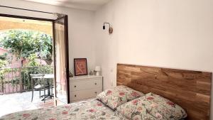 a bedroom with a bed and a sliding glass door at Appartement confort et équipé proche de la plage in Sisco +9 photos