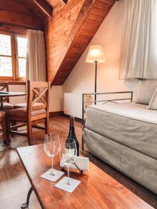 a bedroom with a bed and a table with wine glasses at Hotel Catedral Patagonia Ski & Wellness in San Carlos de Bariloche +148 photos