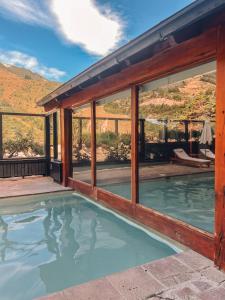 a house with a swimming pool with windows at Hotel Catedral Patagonia Ski & Wellness in San Carlos de Bariloche