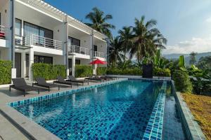 a swimming pool in front of a building at The Blue Lotus in Mae Nam