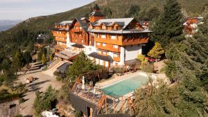 an aerial view of a large house with a swimming pool at Hotel Catedral Patagonia Ski & Wellness in San Carlos de Bariloche