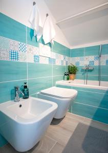 a bathroom with a white sink and a toilet at Mansarda al mare by PortofinoVacanze in Rapallo +28 photos