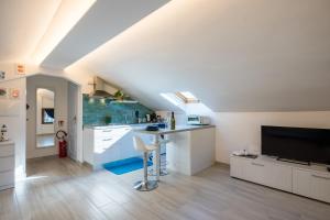 a kitchen with a sink and a counter in a attic at Mansarda al mare by PortofinoVacanze in Rapallo