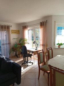 a living room with a desk and a chair at Ferienhaus an der Ronneburg in Ronneburg