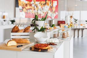 a table with various types of bread and pastries on it at JR Hotels Bari Grande Albergo delle Nazioni in Bari