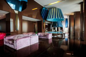 a living room with two couches and a table at JR Hotels Bari Grande Albergo delle Nazioni in Bari