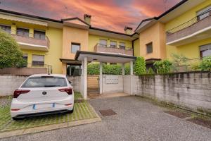 a white car parked in front of a house at 10min Auto Udine Centro Garage coperto Free Wifi in Godia +8 photos