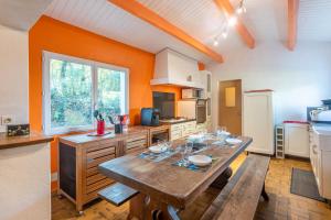 a large kitchen with a wooden table in it at Maison 250m plage - grand jardin in L'Ile d'Yeu