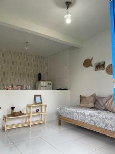 a bedroom with a bed and a table in it at Vila Flor in Cairu