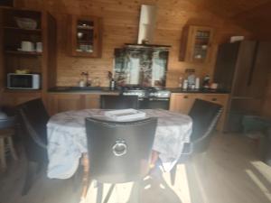 a kitchen with a table and chairs in a kitchen at Chez Francois in Ardres