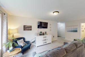 a living room with a couch and two chairs at Lighthouse By The Cove in Seaside