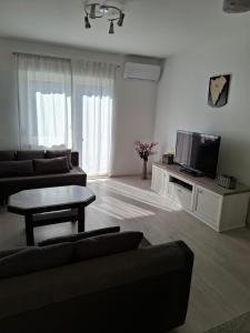 a living room with a couch and a tv at Morena in Pula
