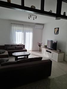 a living room with a couch and a tv at Morena in Pula