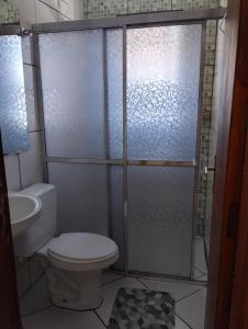 a bathroom with a shower with a toilet and a sink at Casa no Centro in São Lourenço +4 photos
