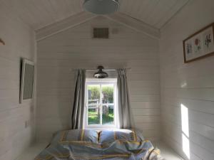 a bedroom with a window and a bed in it at The Den at Husthwaite Gate in Husthwaite