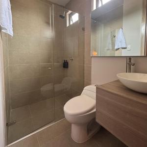 a bathroom with a shower and a toilet and a sink at Casa Rio in Mangue +11 photos