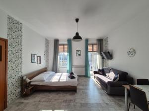 a bedroom with a bed and a couch at Villa Kaszubska in Ustka
