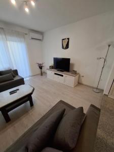 a living room with a couch and a tv at Morena in Pula