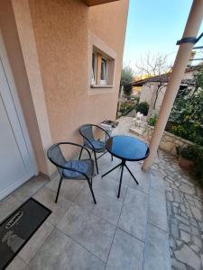 a patio with two chairs and a table at Morena in Pula