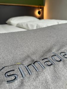 Cama ou camas em um quarto em Hotel Simader