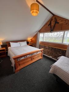 a bedroom with two beds and a window at Hunston Mill Self Catering Dog Stay For Free in Chichester