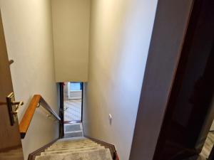 a set of stairs in a room with a door at Midtown Apartment in Ardara +5 photos