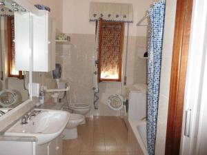 a bathroom with a sink and a toilet and a shower at La Margherita di Teriasca in Teriasca
