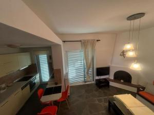 a living room with a kitchen and a dining room at Elegant maisonette in Pefkohori in Pefkohori